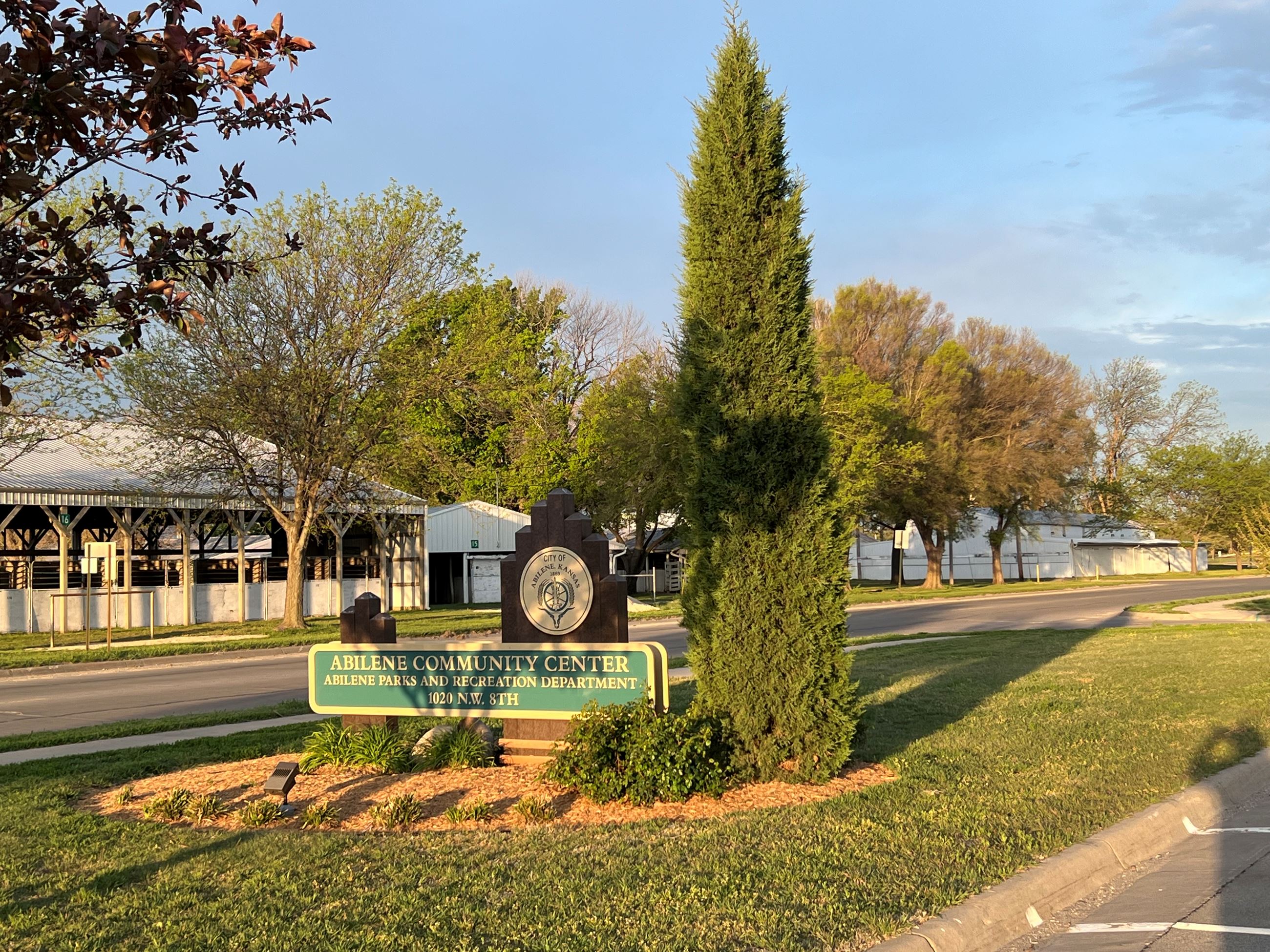 Abilene Community Center Sign with flowers and trees around the sign