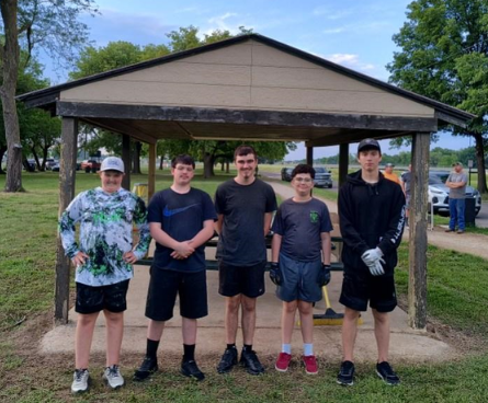 Five Eagle Scouts standing in front of a park picnic shelter.
