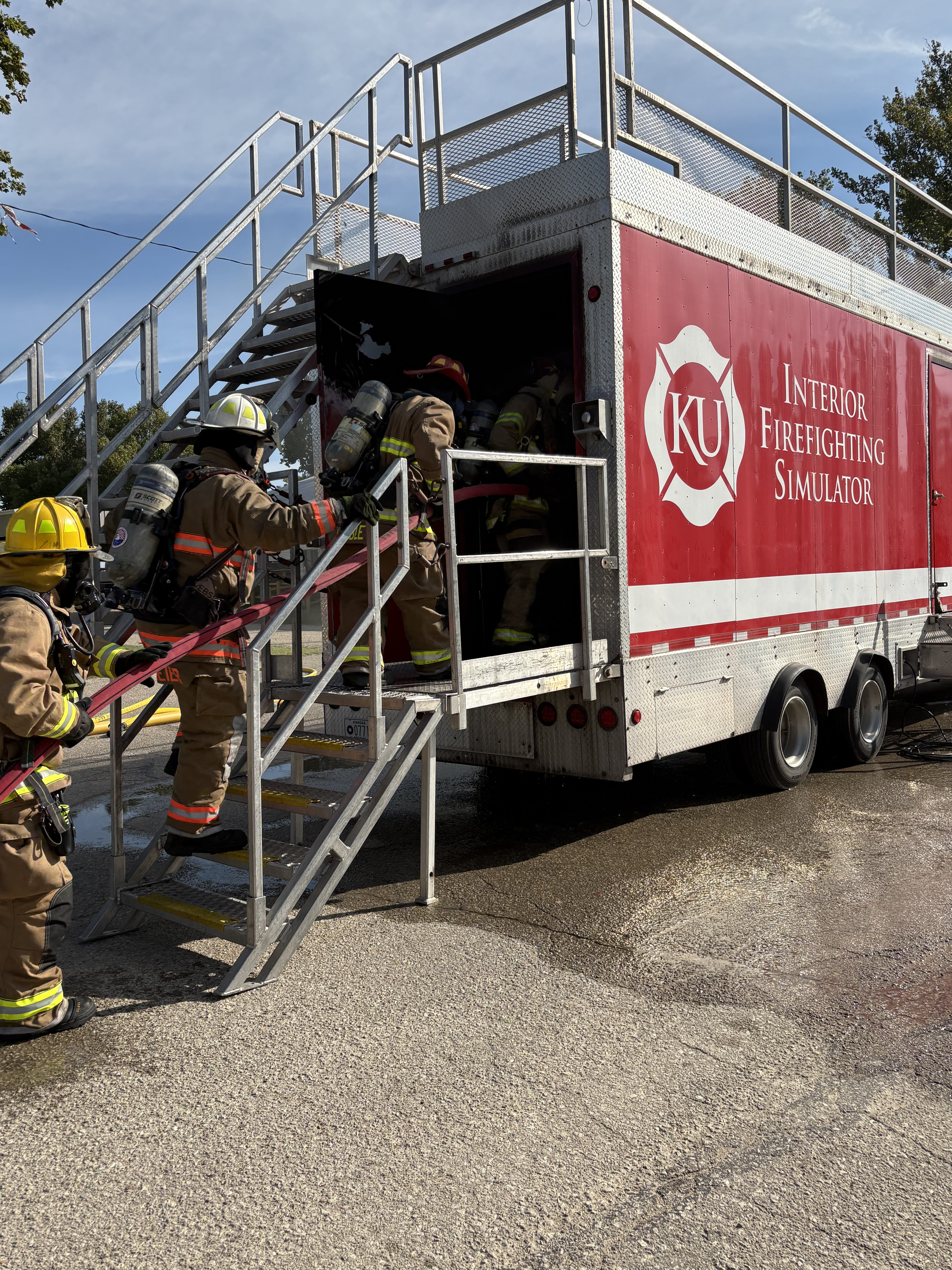 Firefighters enter the KU Fire & Rescue Training Institute simulator for interior fire training.