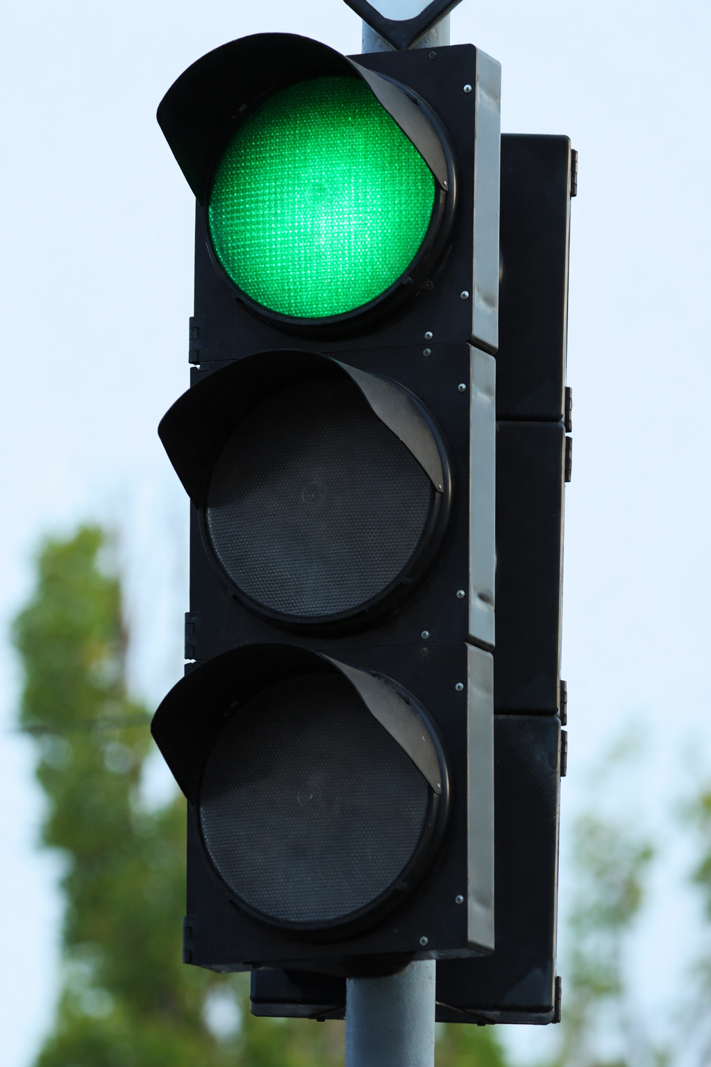 Traffic signal showing green light illuminated.